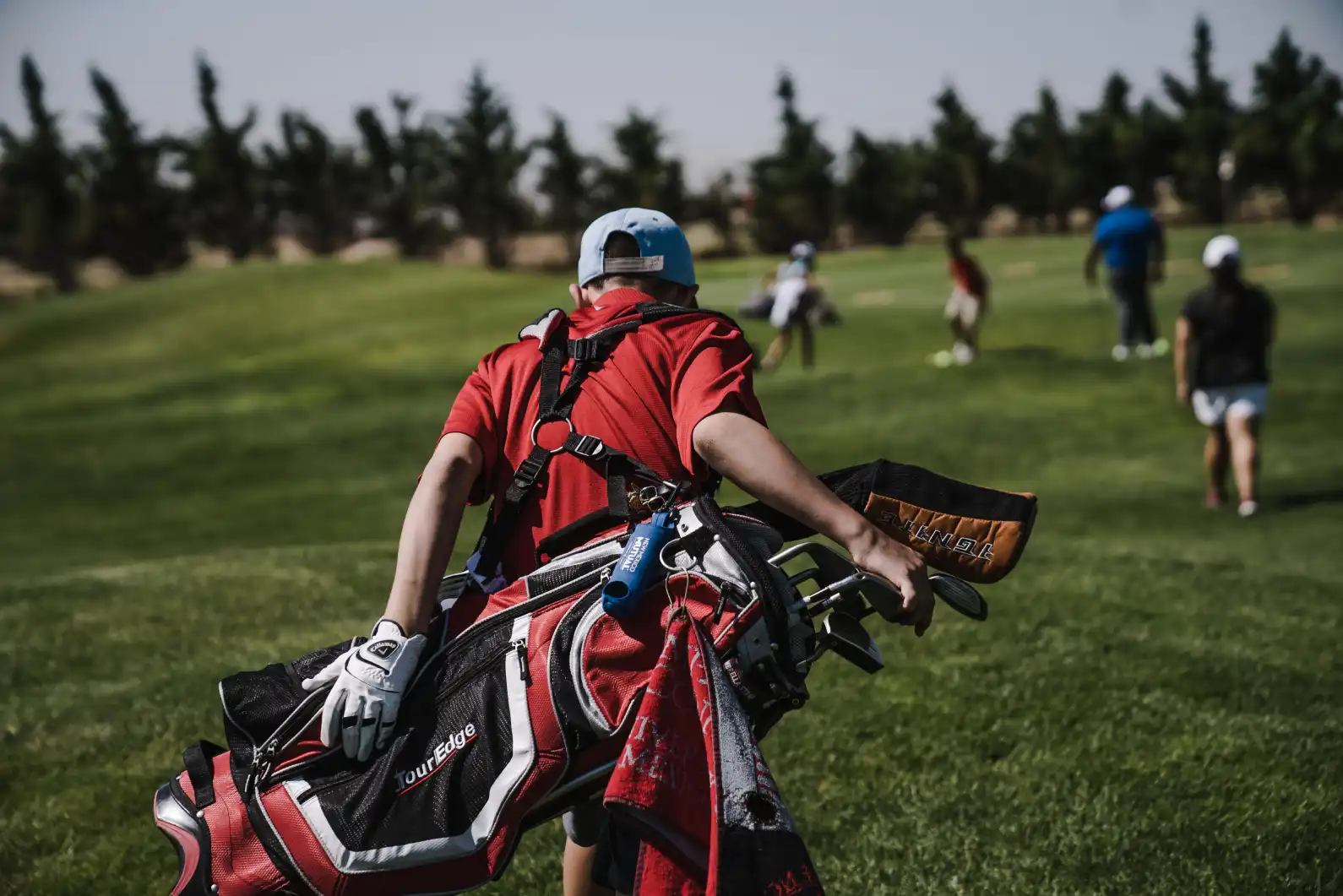 Junior Tour Performance Golf Academy Students lined up with their golfing equipment.